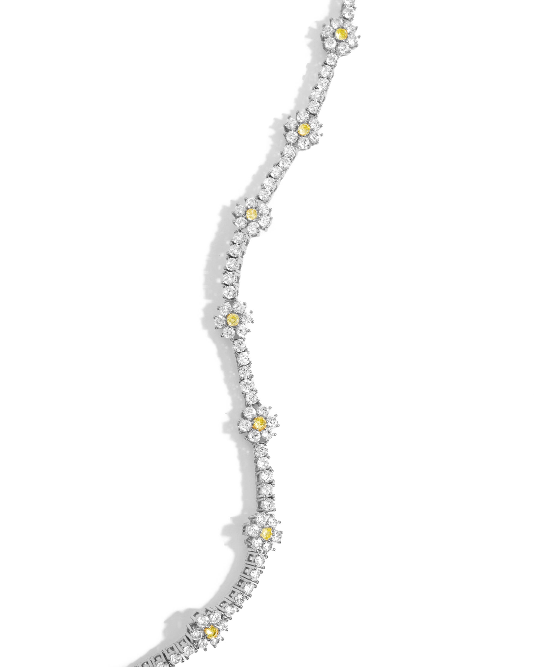 Silver necklace with small yellow stones in a floral design on a white background