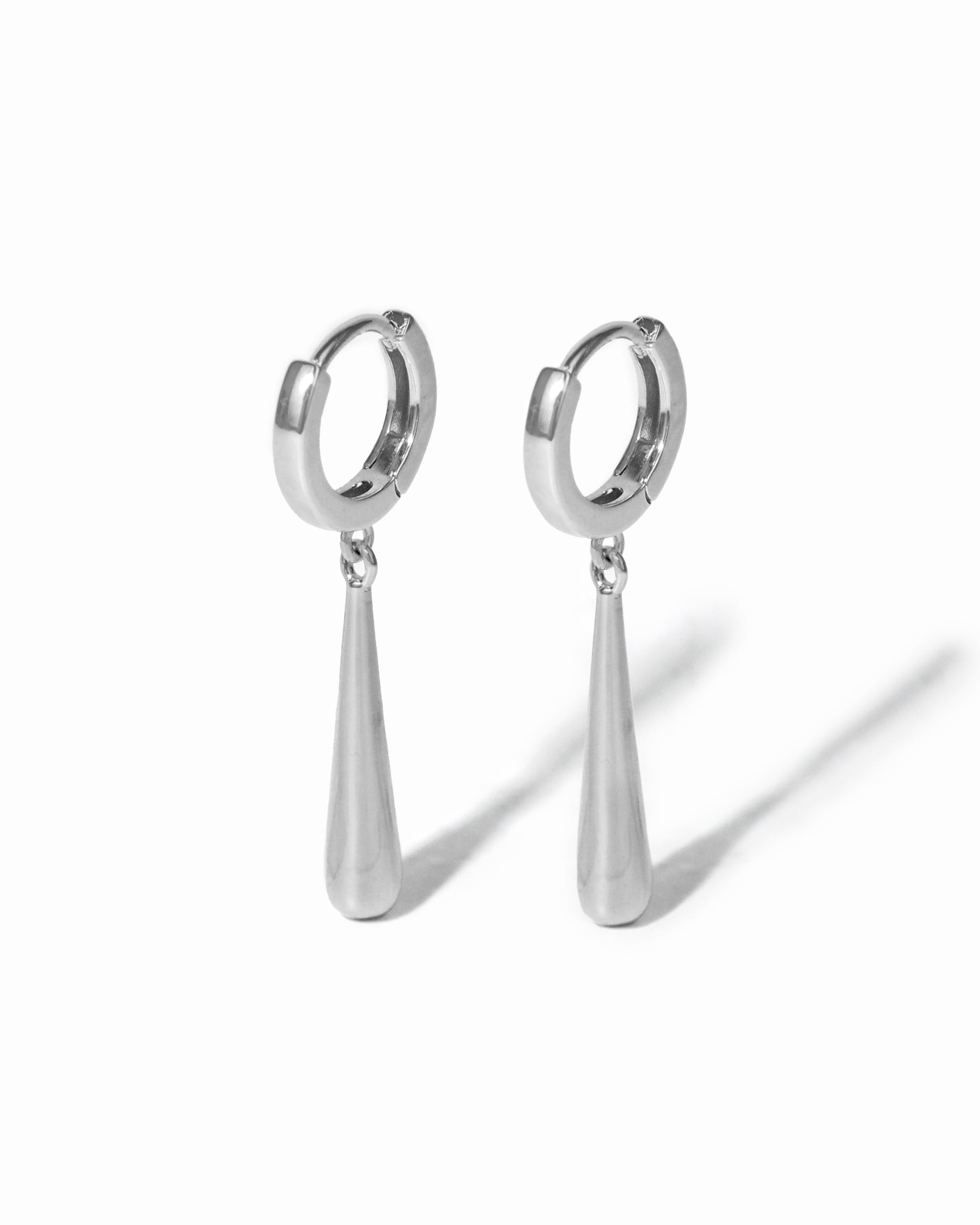pair of silver dangle drop earrings on a white background