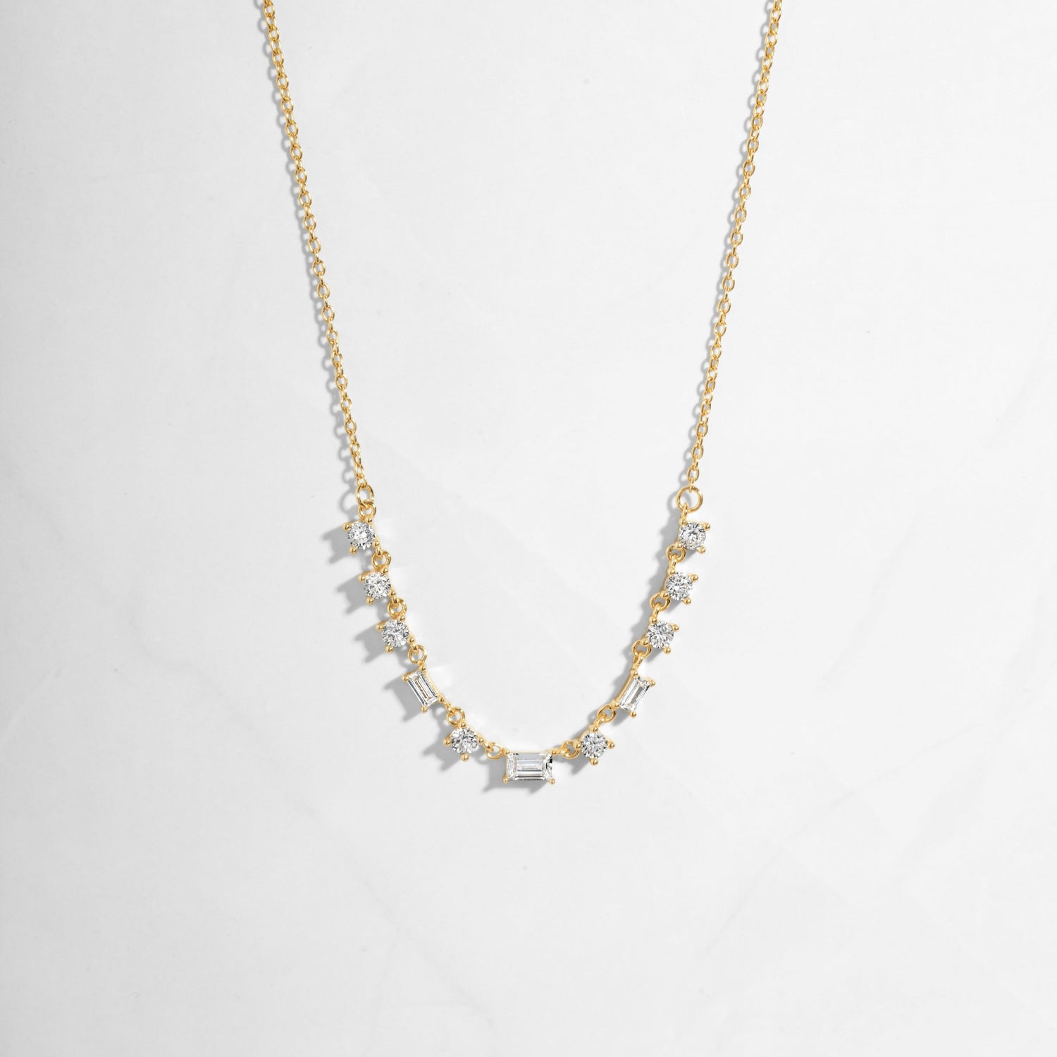 Closeup image of gold diamond baguette necklace 