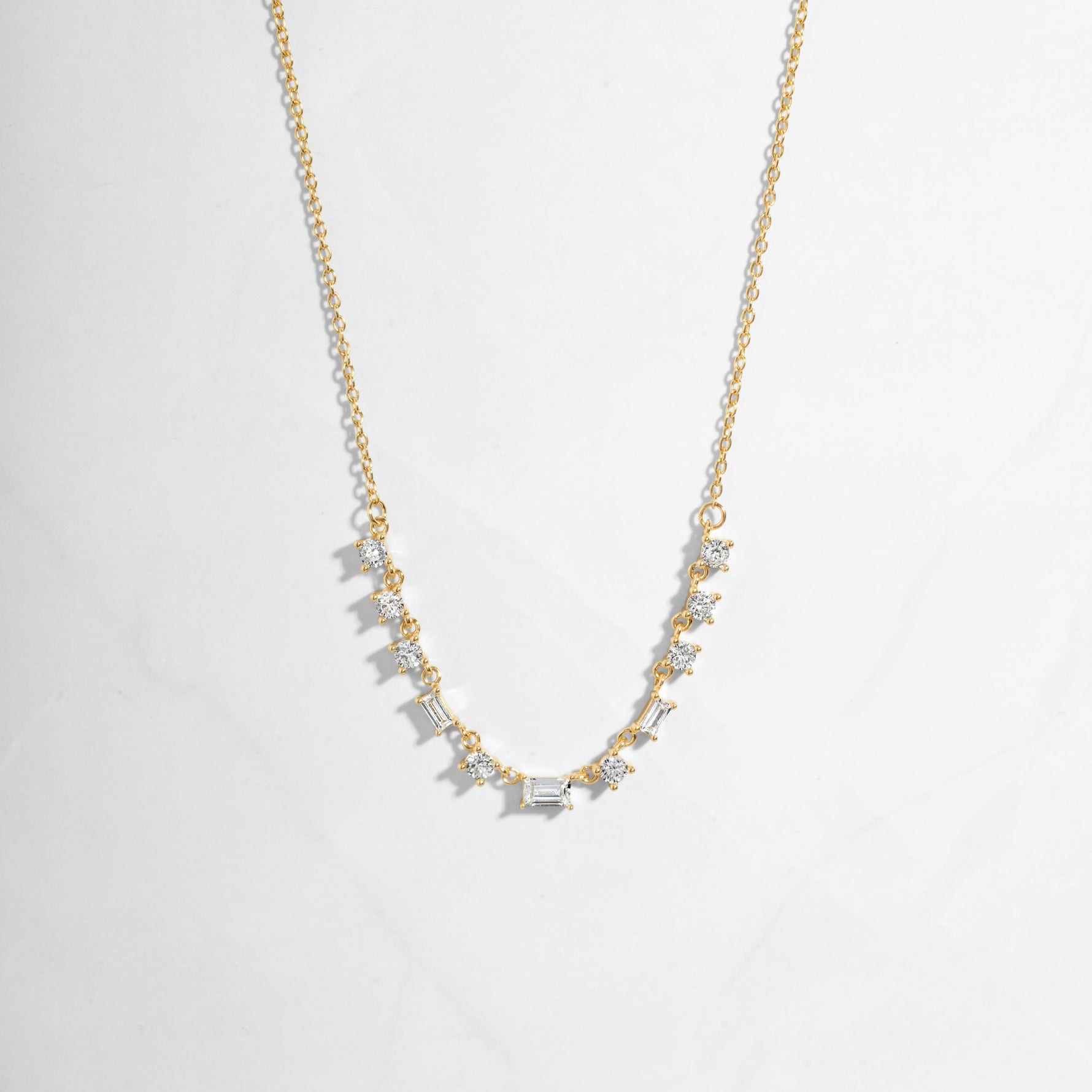 Closeup image of gold diamond baguette necklace 
