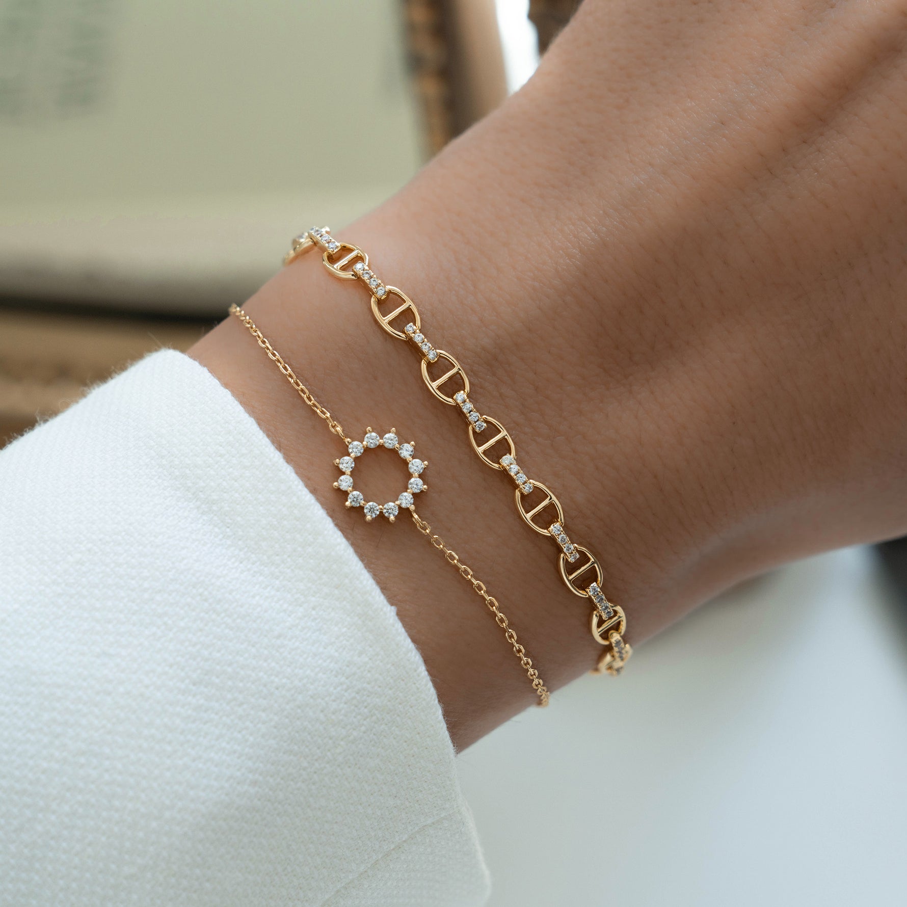 Model pairing Diamond Bracelet with sun burst bracelet for a modern stacked style.