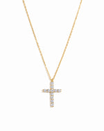 Gold large cross pendant with diamonds on a white background