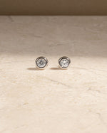 Silver tiny earrings on a marble background