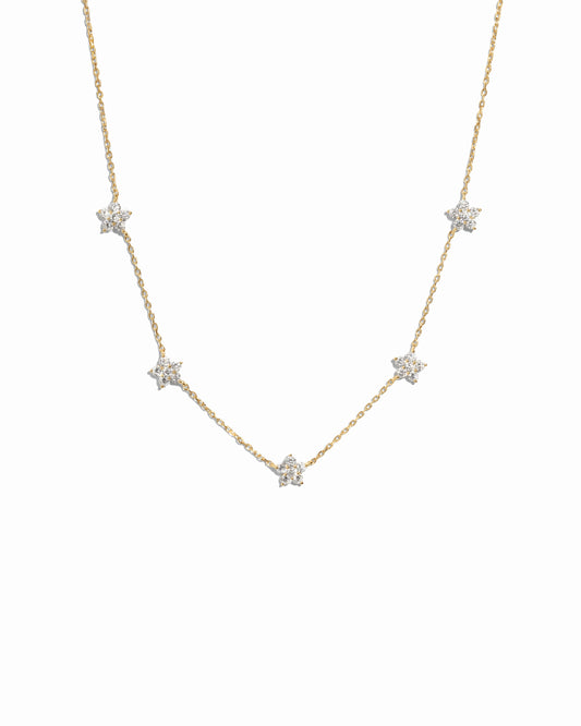 Dainty delicate gold opal flower charm necklace on white background
