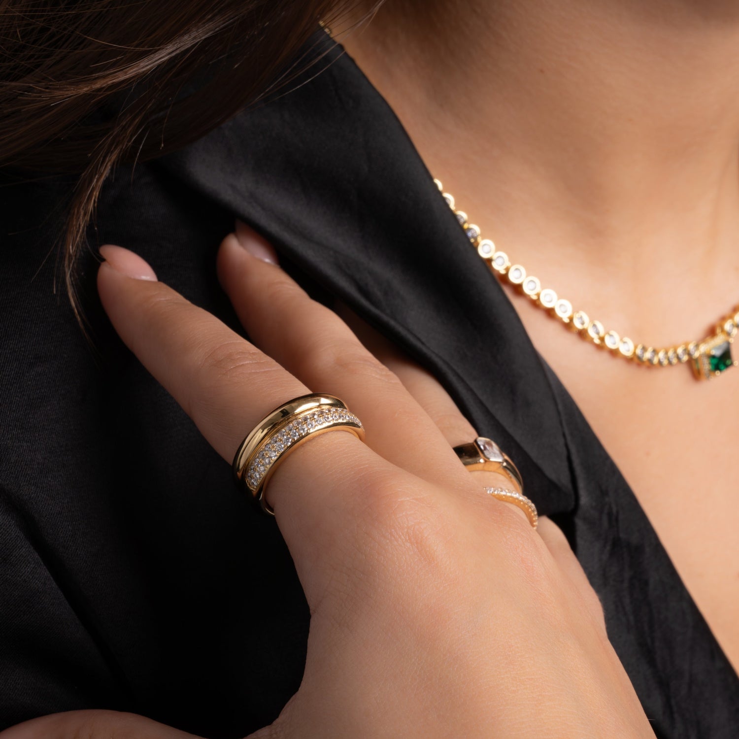 model wearing statement jewelry featuring chunky gold ring