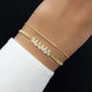model wearing gold jewelry featuring diamond bracelet with gold MAMA chain on gold chain