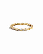 Closeup image of gold eternity band with pave diamonds