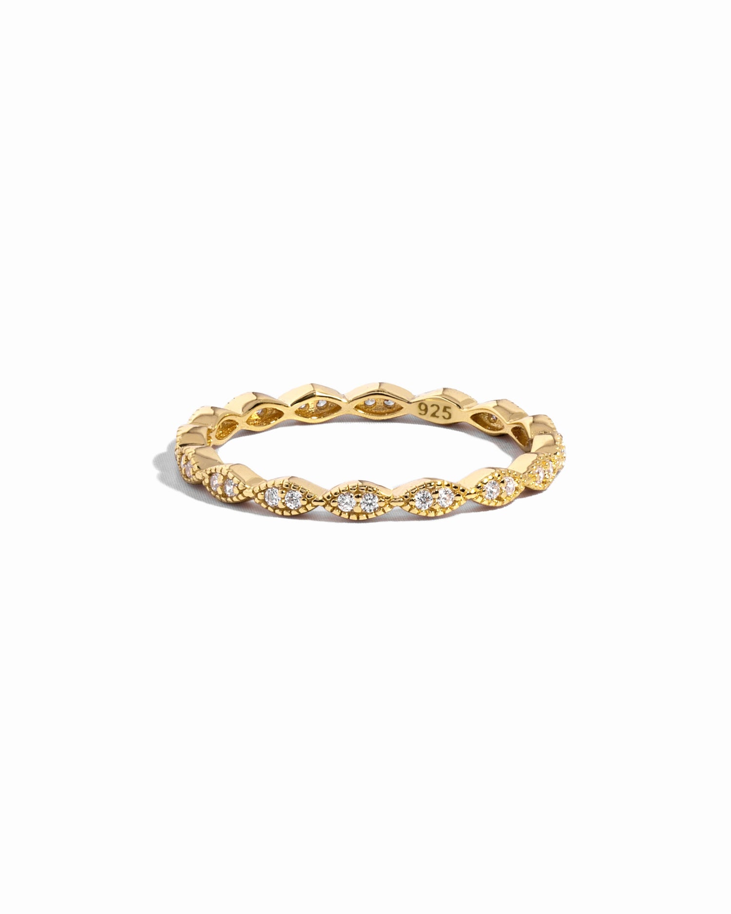 Closeup image of gold eternity band with pave diamonds