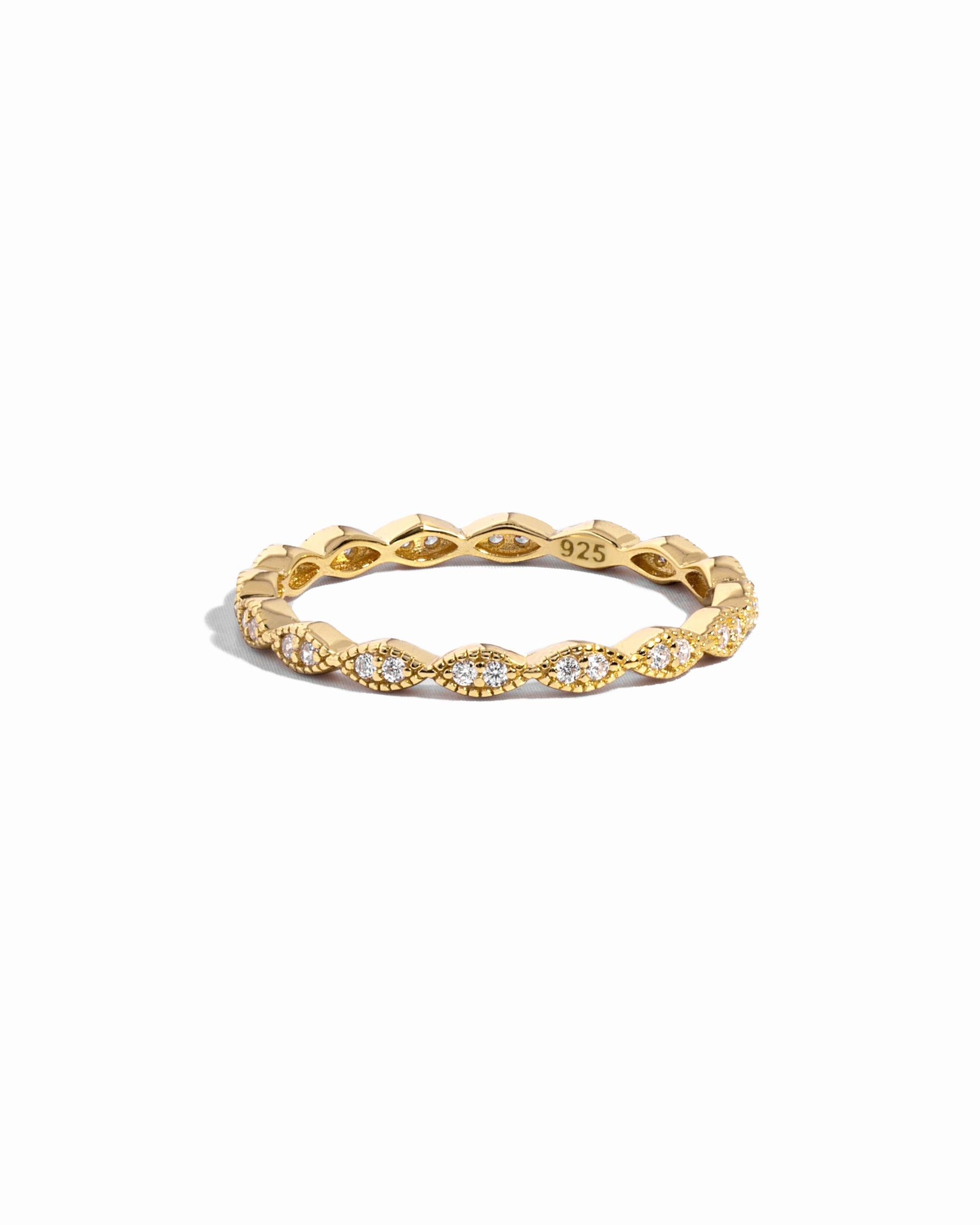 Closeup image of gold eternity band with pave diamonds