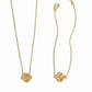 closeup image of gold four leaf clover pendant necklace and matching charm bracelet
