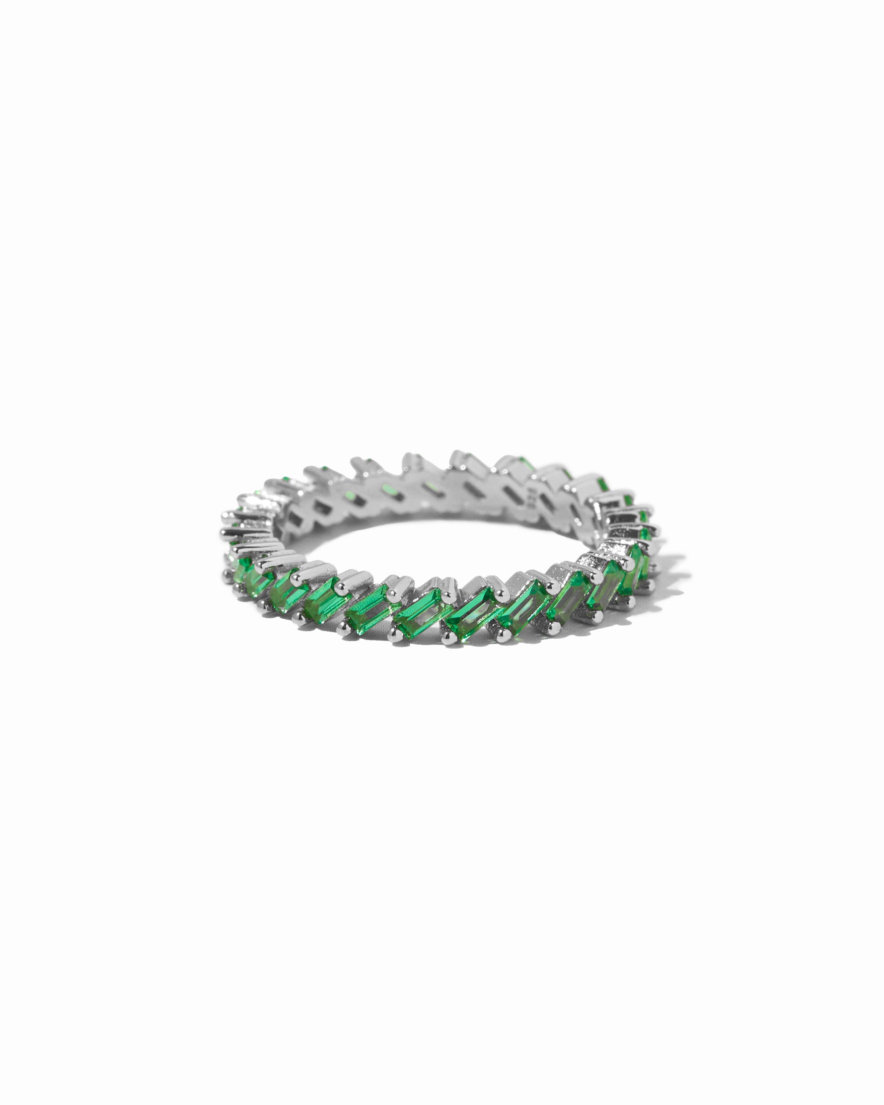 Sterling silver emerald statement slanted baguette ring on white background
