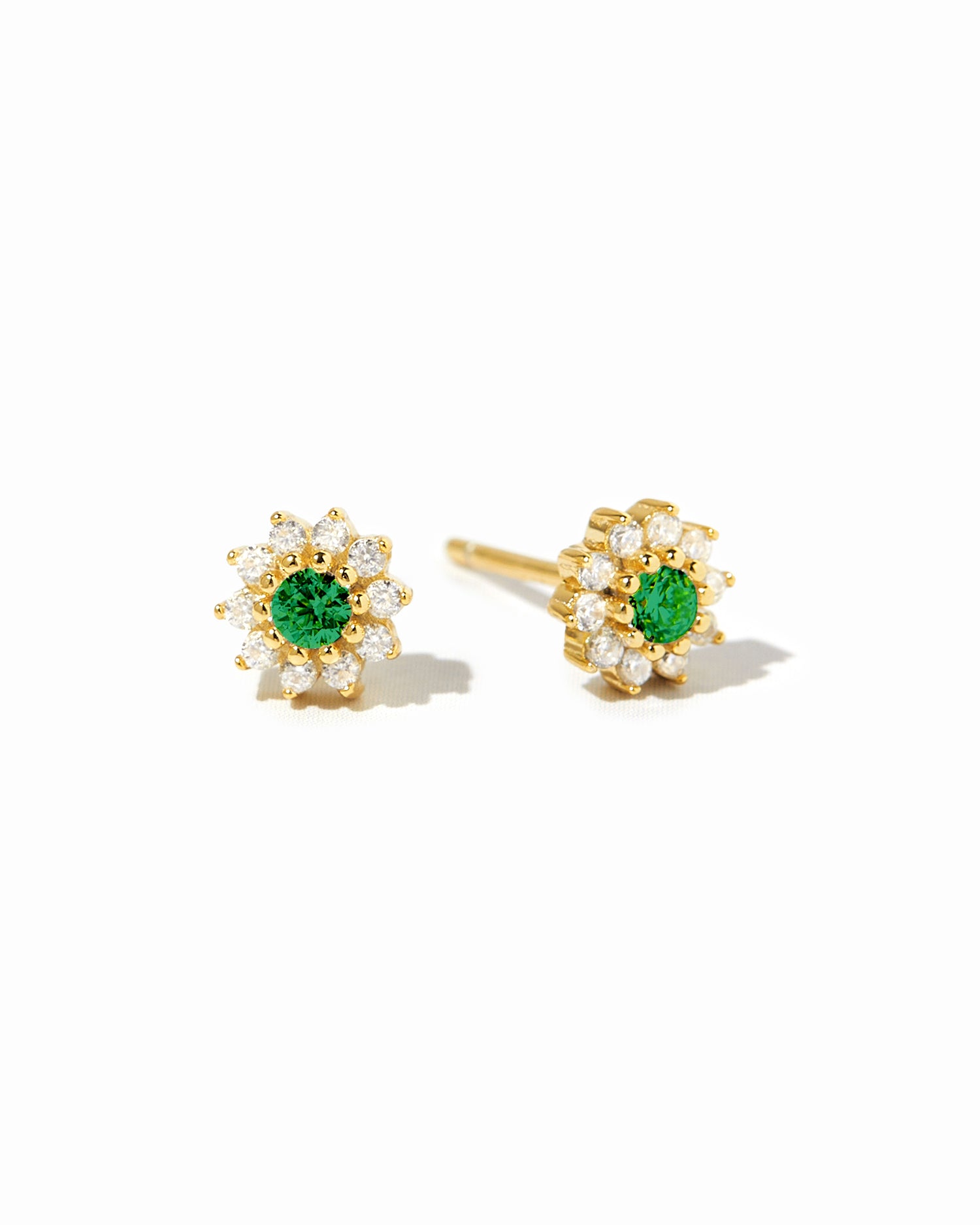 Dainty gold emerald flower stud earrings. 