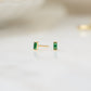 closeup image of gold emerald earrings