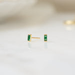 closeup image of gold emerald earrings