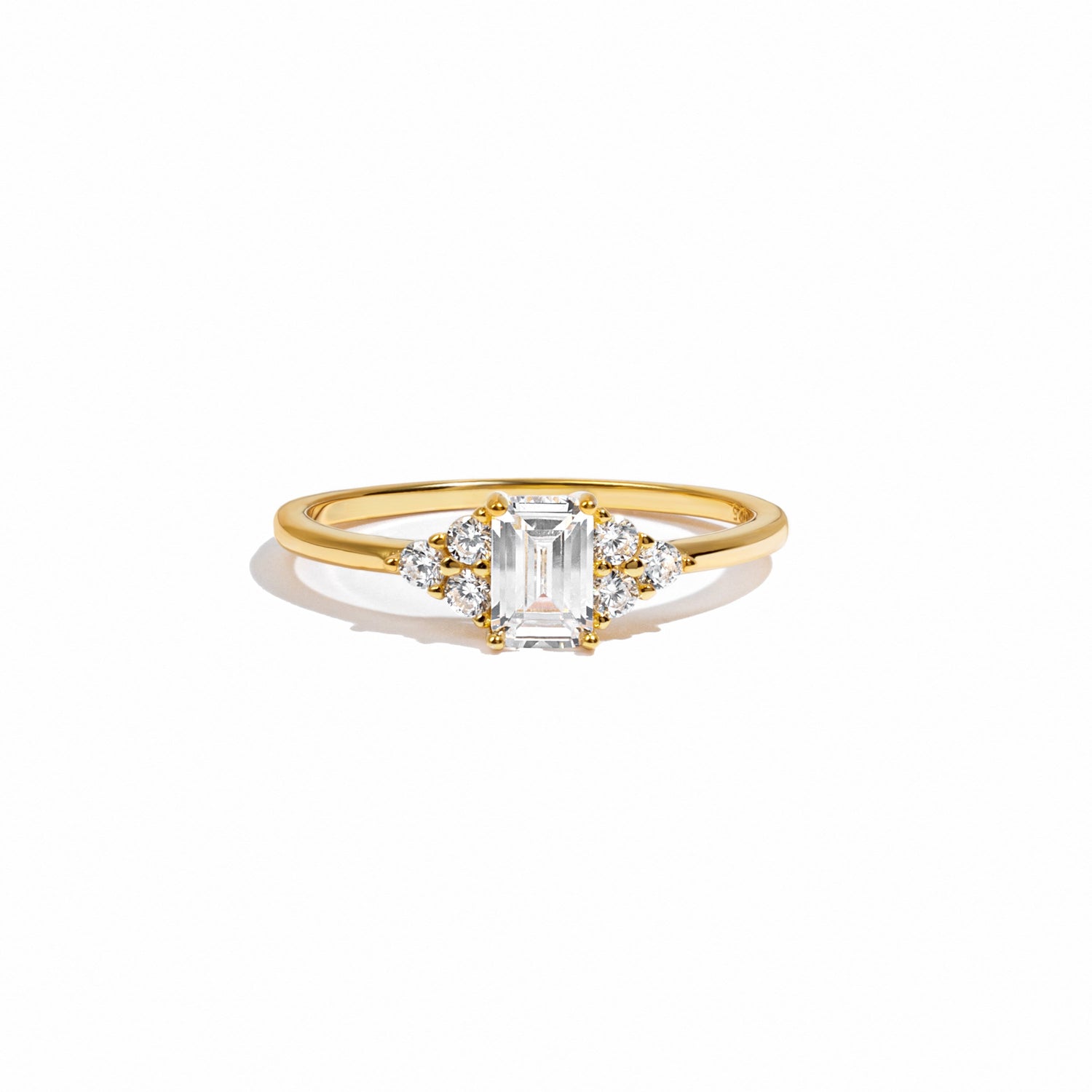 closeup image of gold emerald cut stacking ring