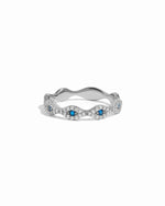 Silver evil eye ring with blue gemstones on a white background