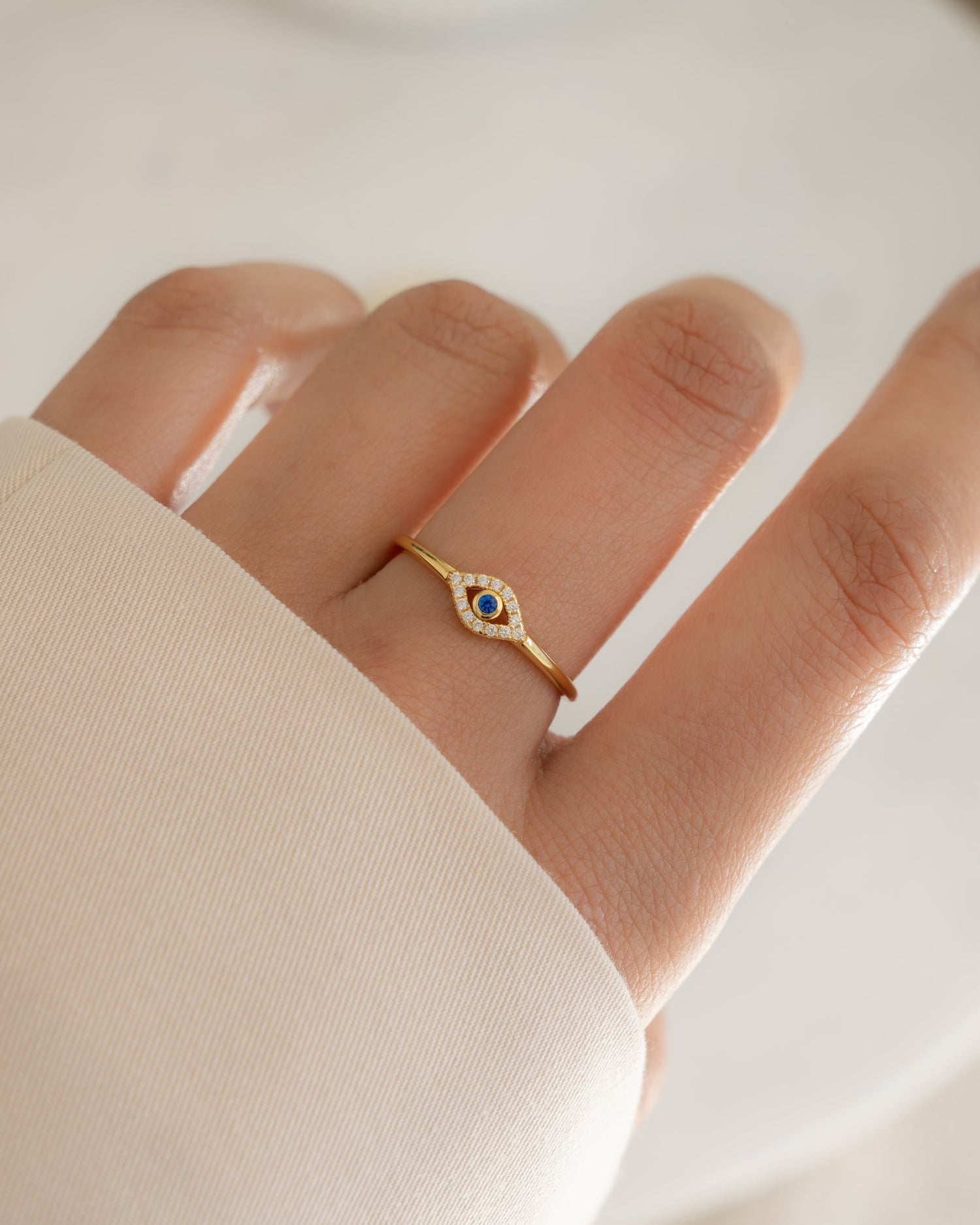 closeup image of gold evil eye ring