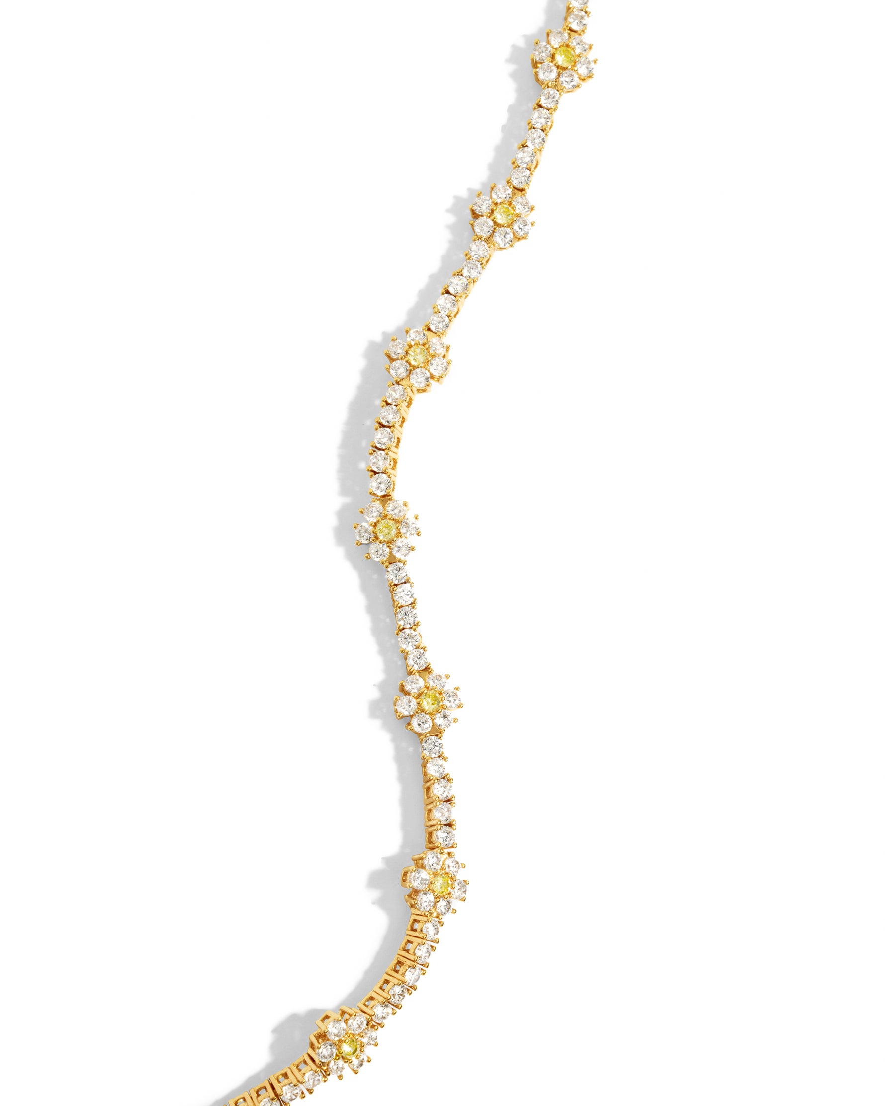 Gold tennis bracelet with daisy floral design