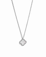 Silver necklace with a clover-shaped pendant on a white background