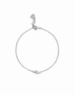 Silver chain bracelet with freshwater pearl charm on a white background