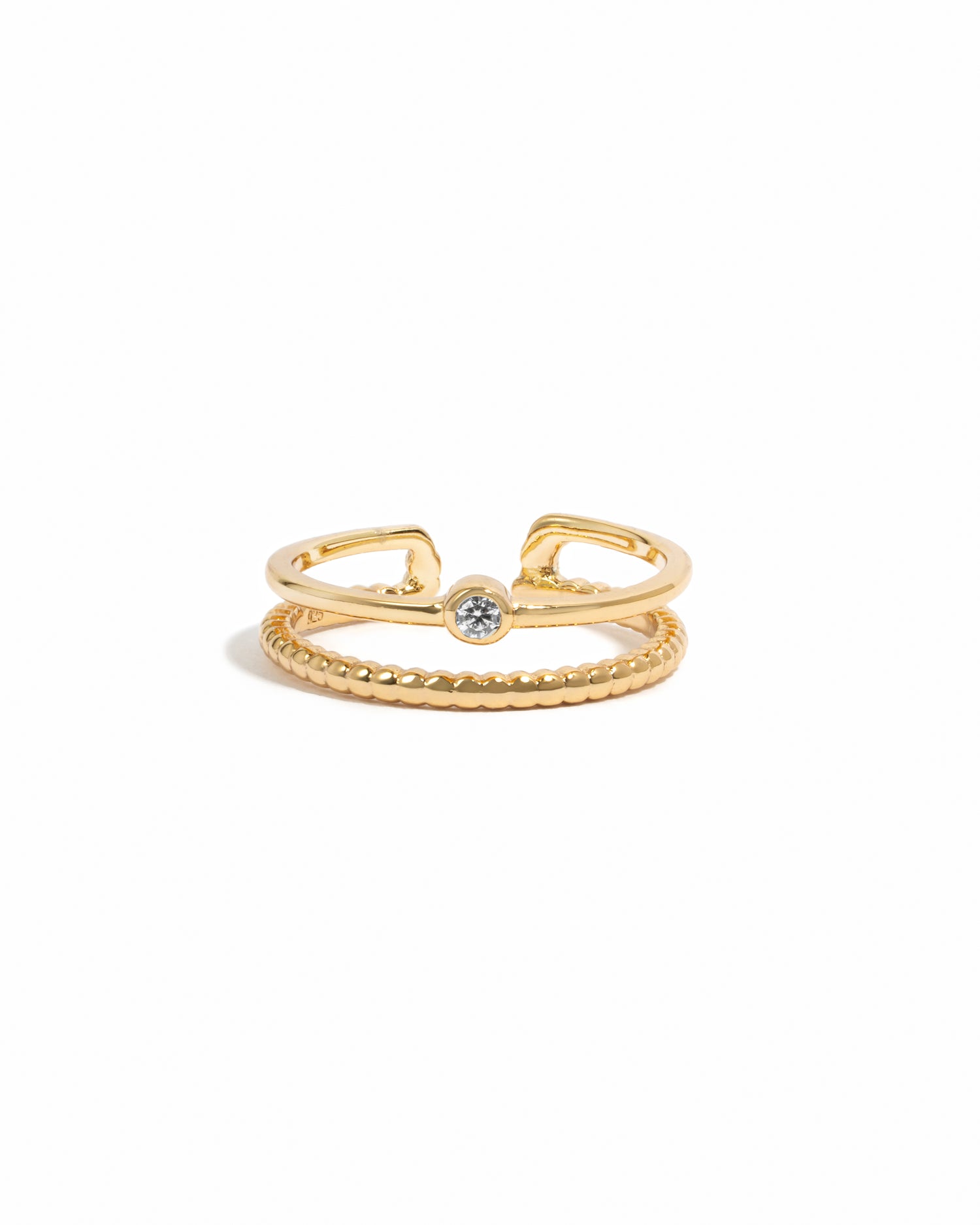 Gold bezel toe ring on a white background