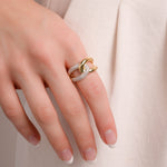 Model wearing criss cross ring in gold and sterling silver