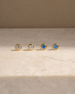 Gold diamond earrings featuring cubic zirconia stud earrings and aquamarine stud earrings