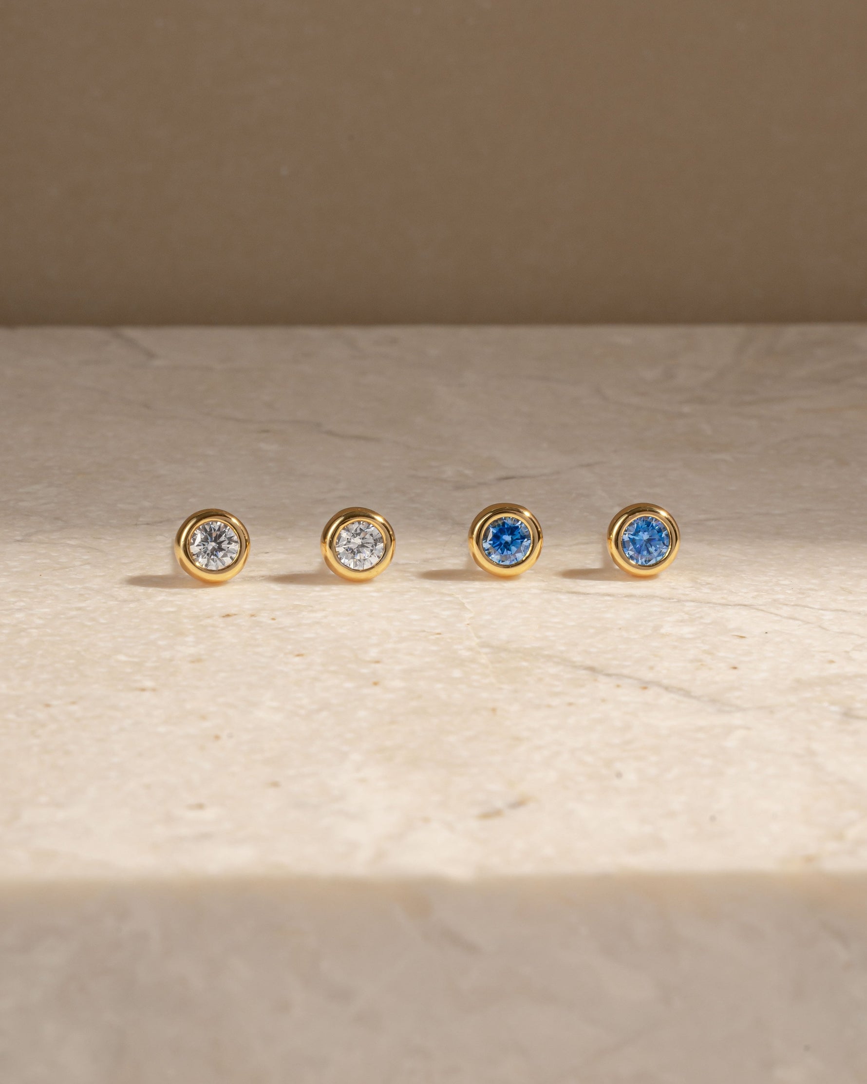 Gold diamond earrings featuring cubic zirconia stud earrings and aquamarine stud earrings