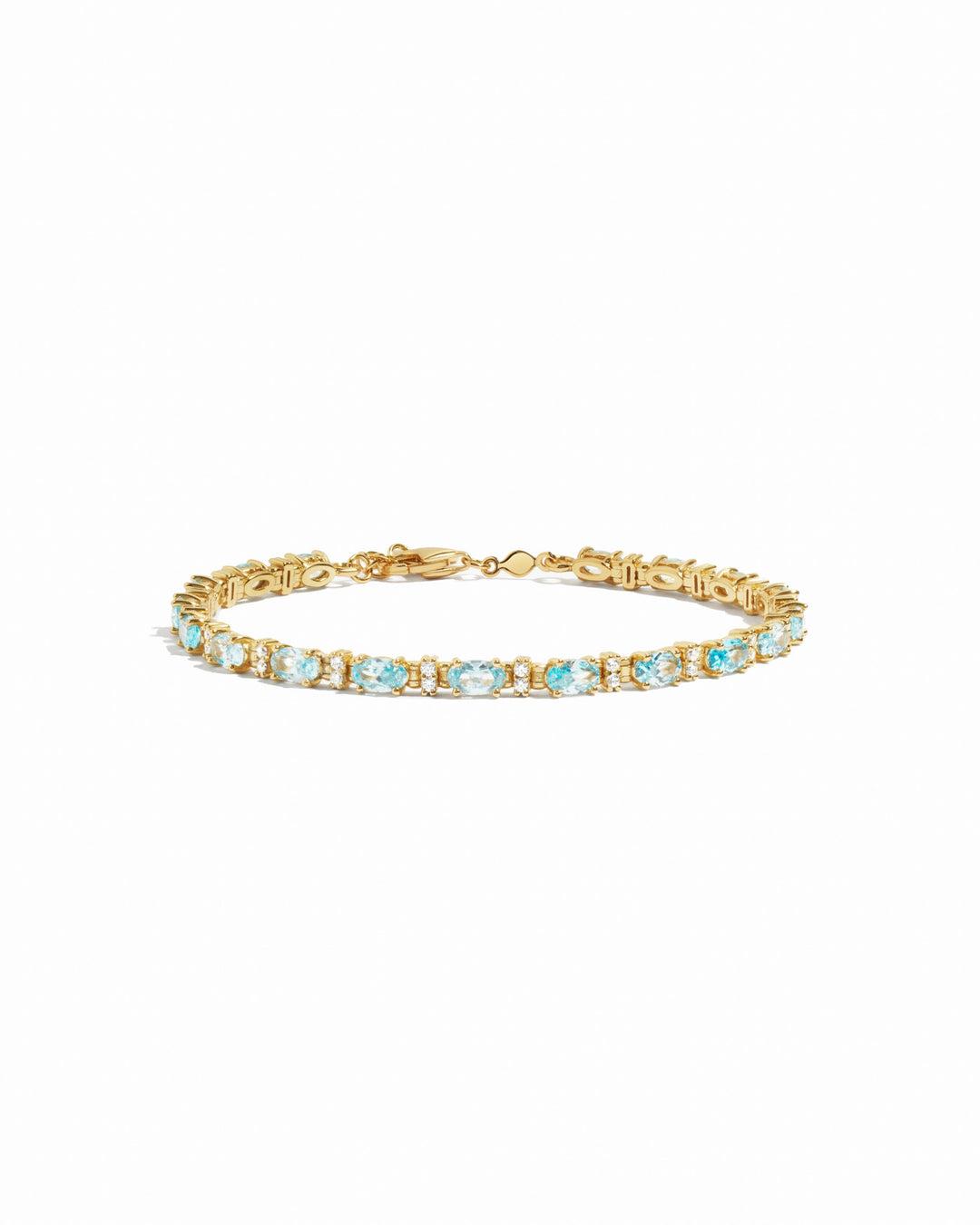 closeup image of gold aquamarine tennis bracelet