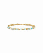 closeup image of gold aquamarine tennis bracelet