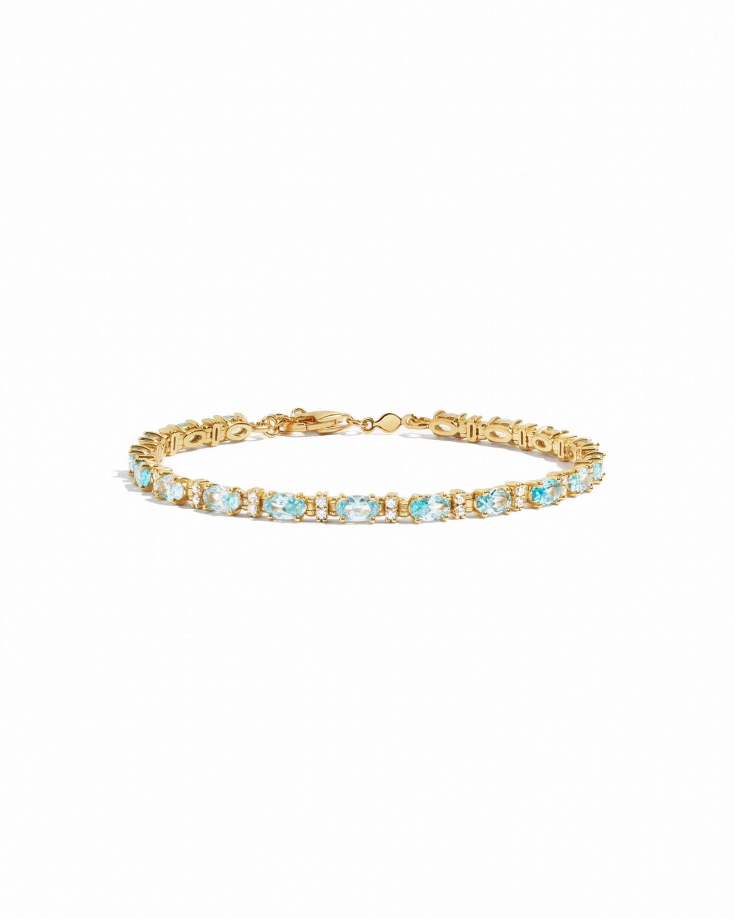 closeup image of gold aquamarine tennis bracelet