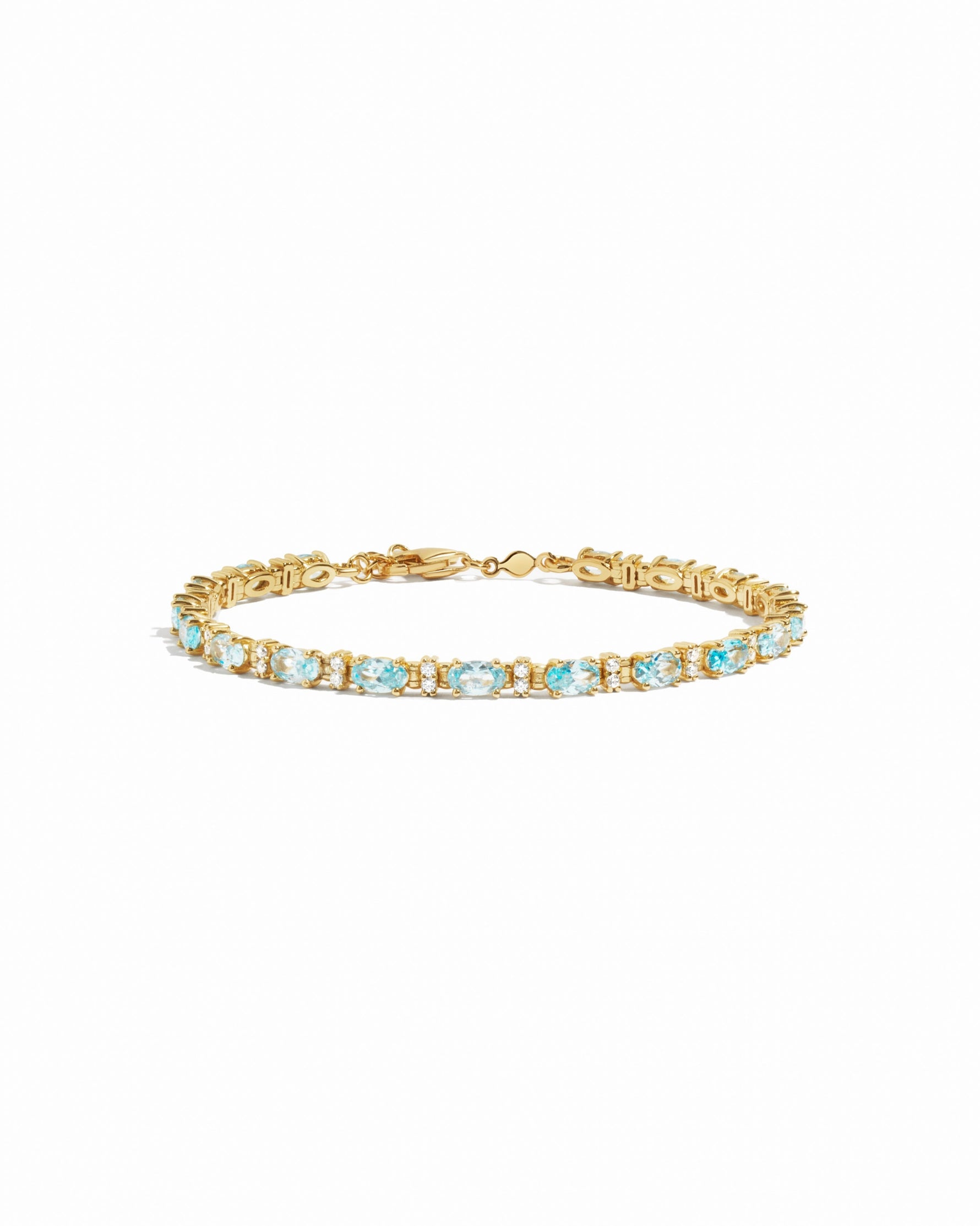 closeup image of gold aquamarine tennis bracelet
