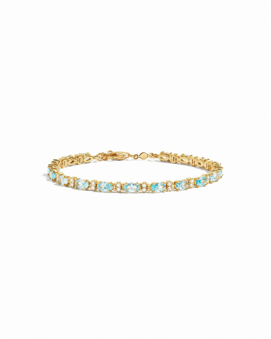 closeup image of gold aquamarine tennis bracelet