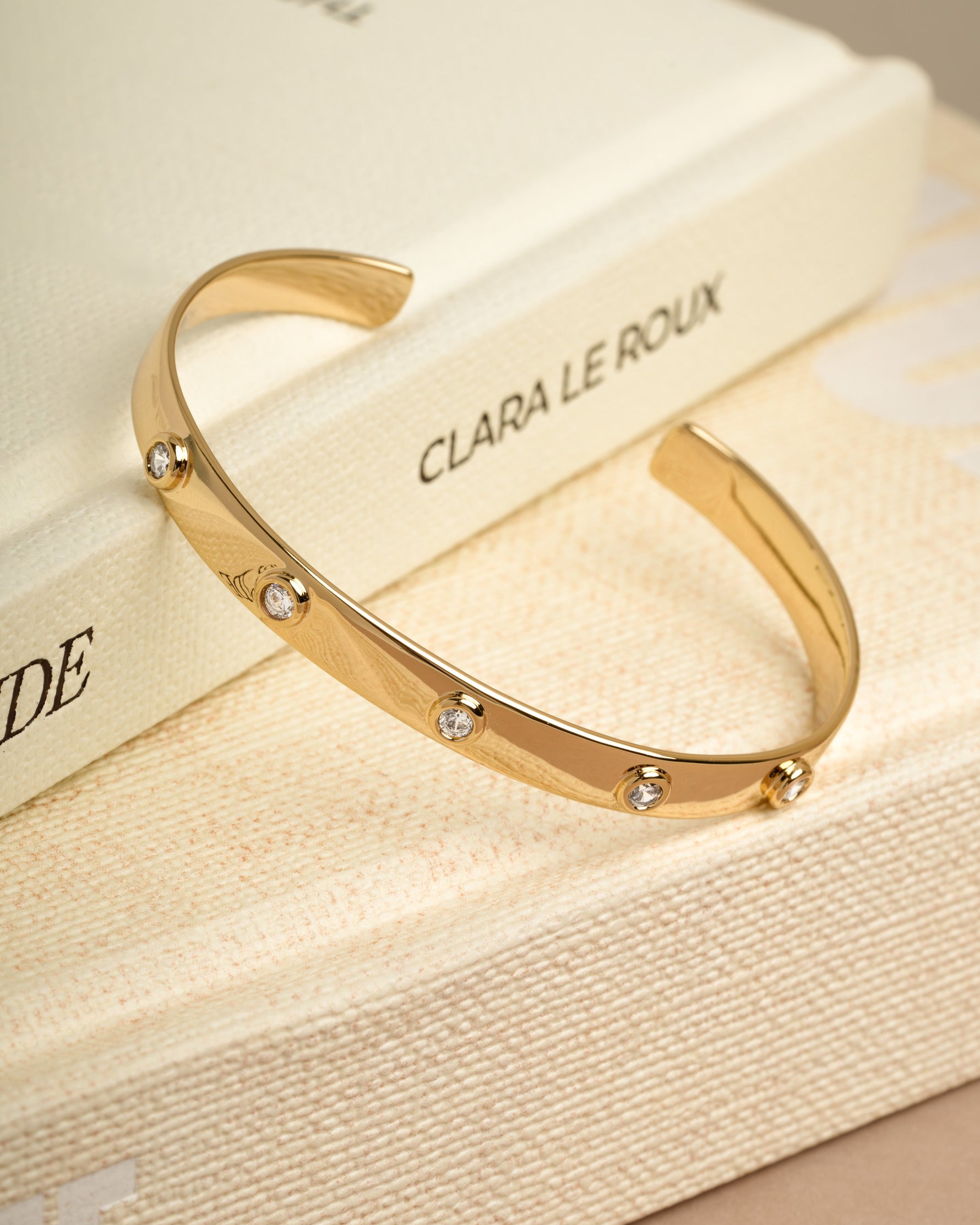 Gold bangle bracelet on a decorative book