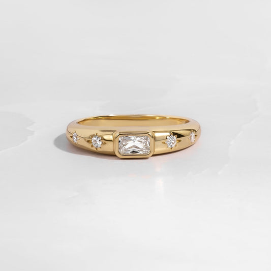 Gold baguette starburst band with tiny diamonds on white background