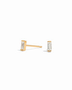 closeup image of minimalist gold earrings on a white background