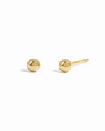 Dainty gold ball stud earrings.