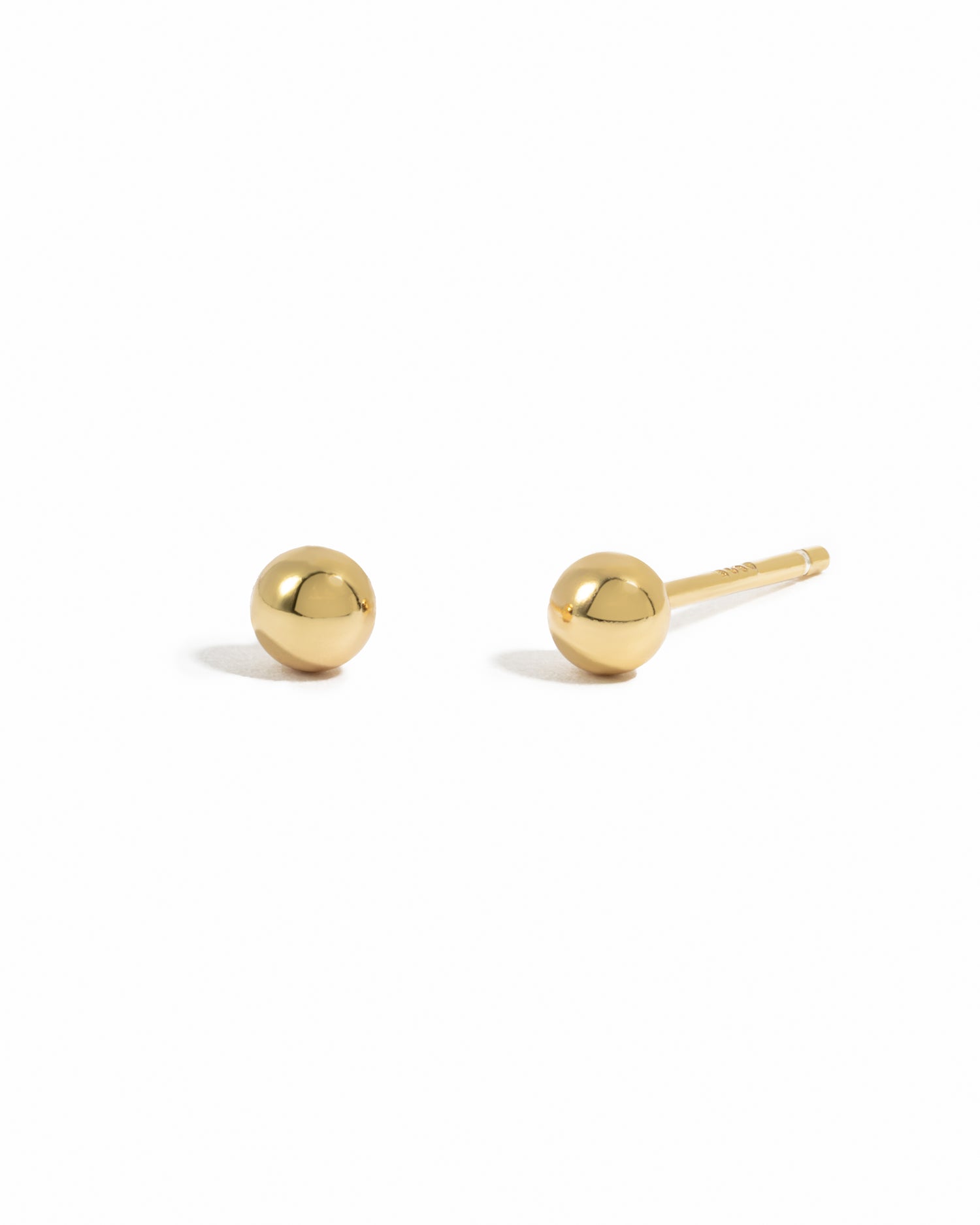 Dainty gold ball stud earrings.