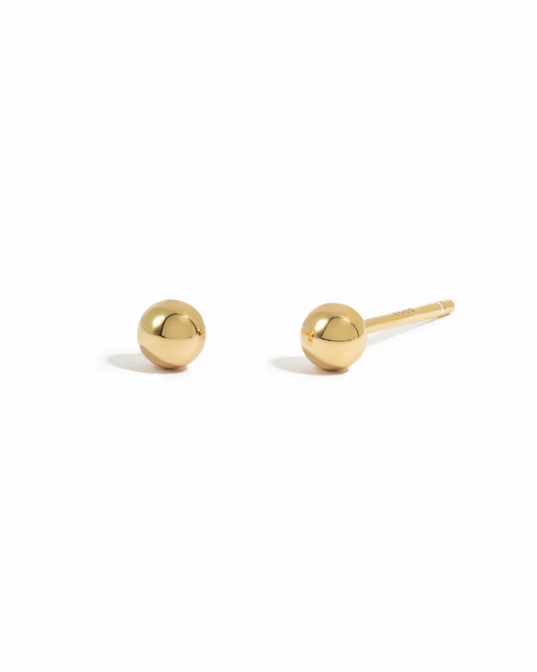 Dainty gold ball stud earrings.