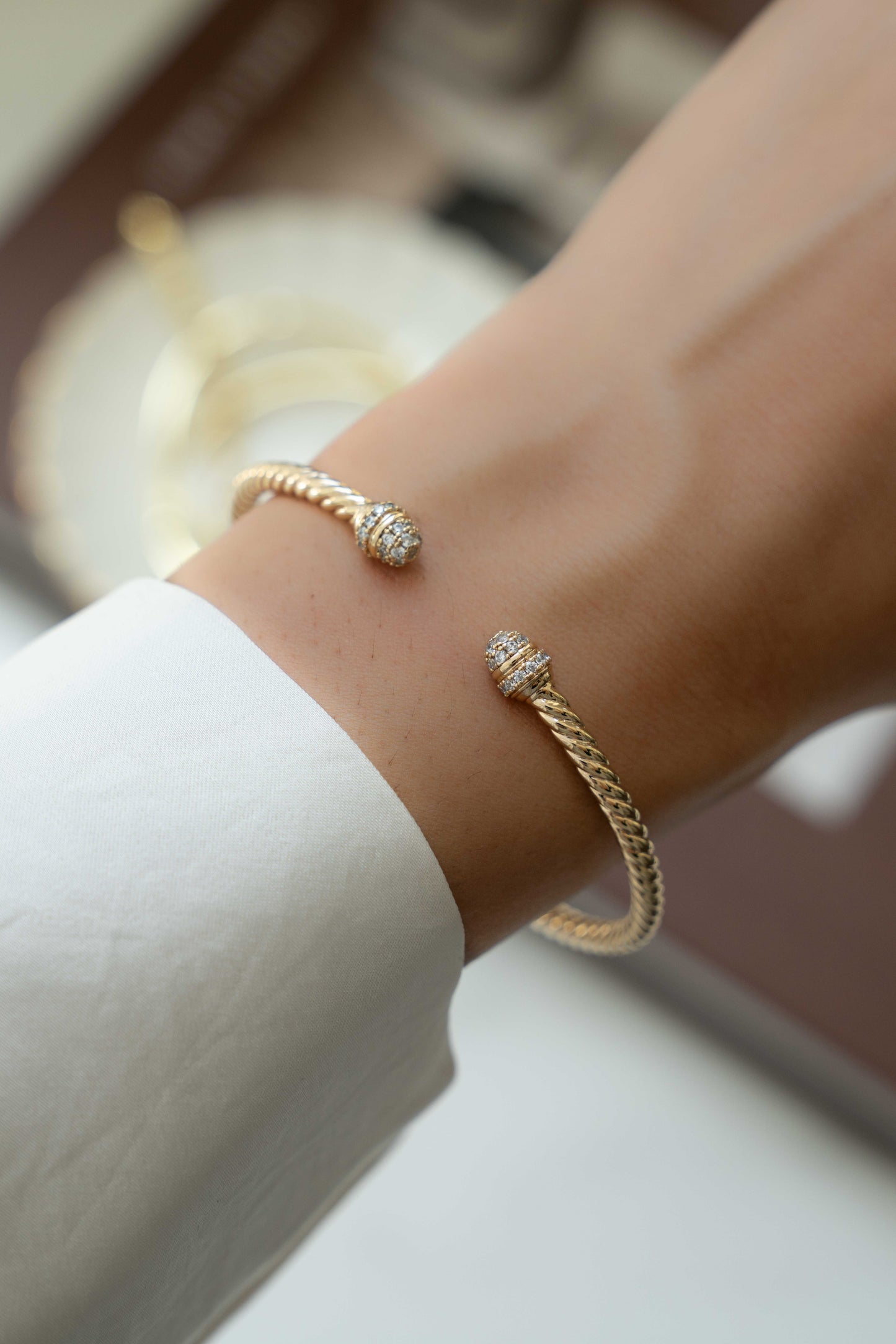 model wearing gold bangle bracelet