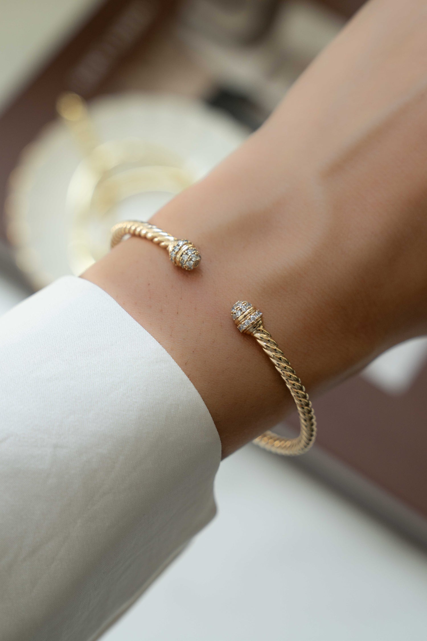 model wearing gold bangle bracelet