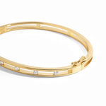 closeup image of gold studded bangle bracelet