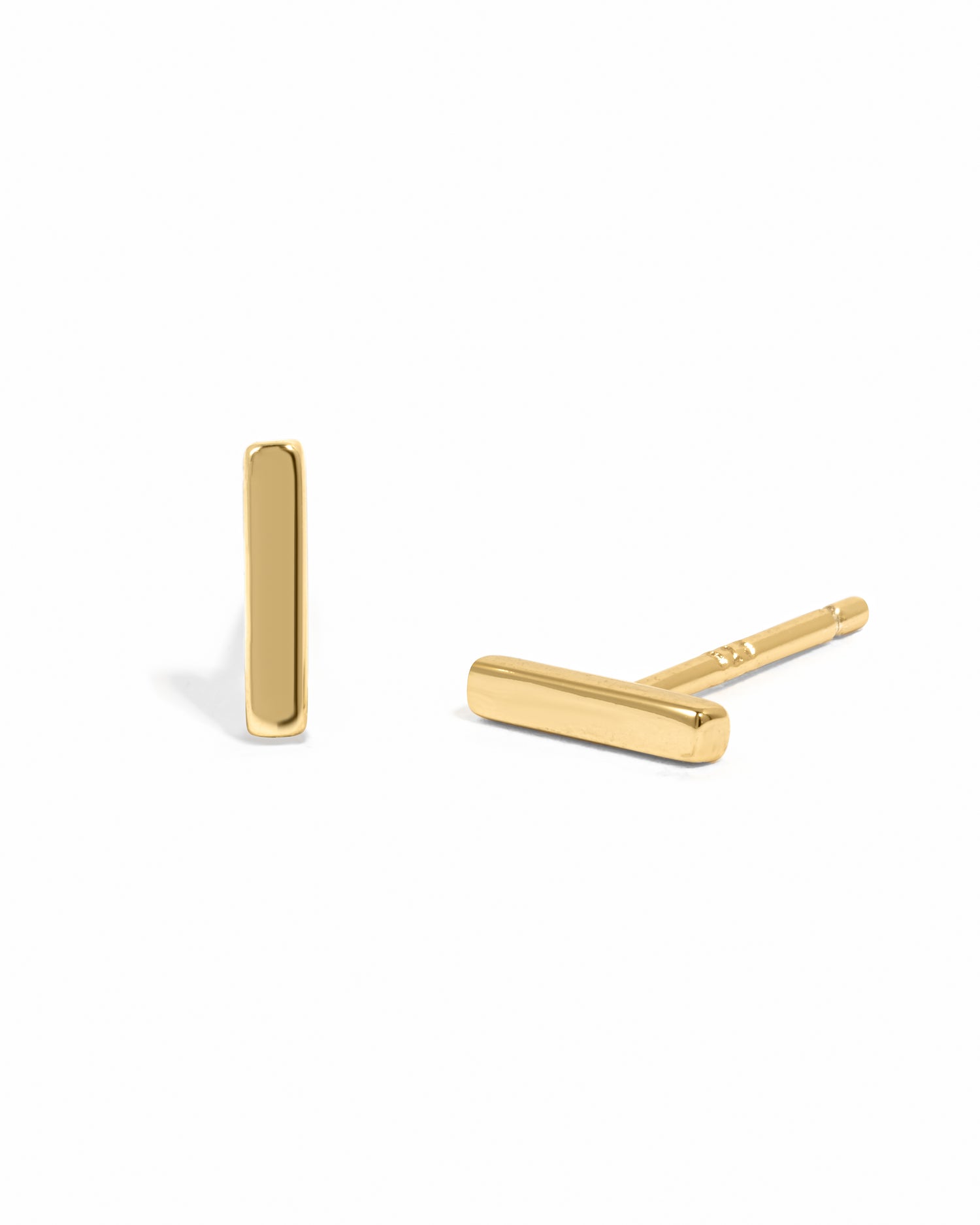 Gold bar-shaped stud earrings on a white background
