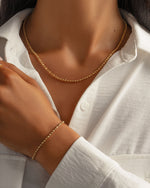 Gold diamond beaded necklace and matching dainty chain bracelet on model