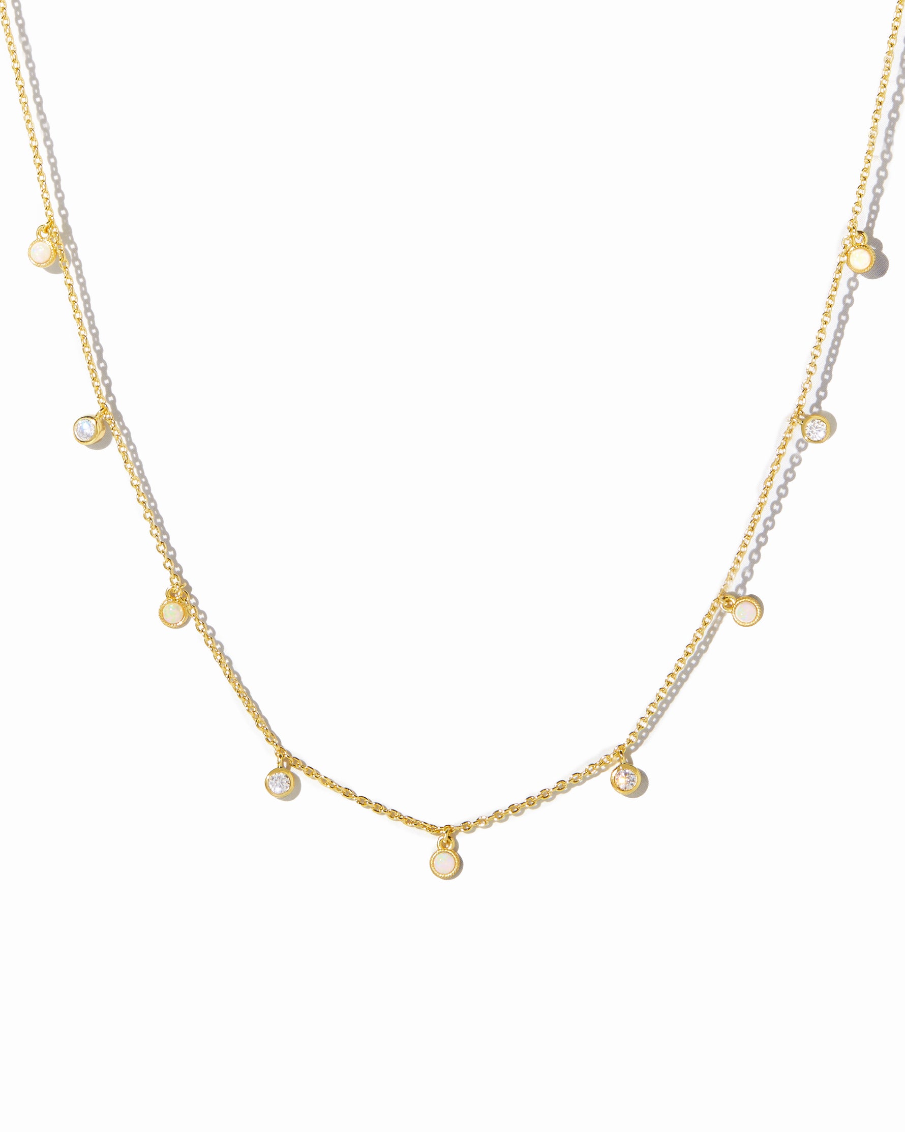 gold beaded charm necklace with opal and cubic zirconia stones