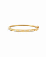 Gold diamond bangle with small cubic zirconia stones on a white background