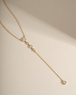 Gold minimalist necklace featuring a diamond pendant design
