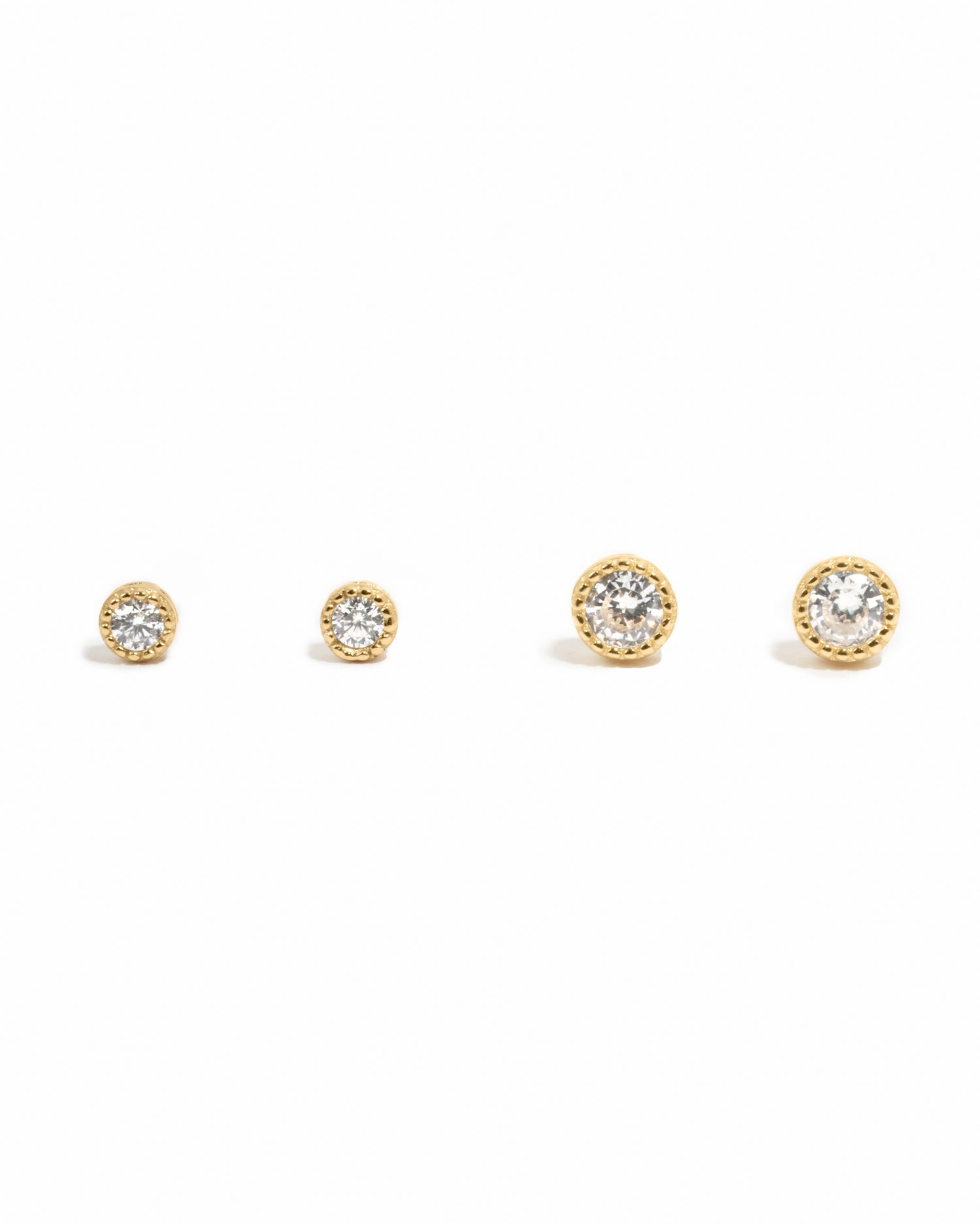 Two pairs of gold diamond stud earrings on a white background