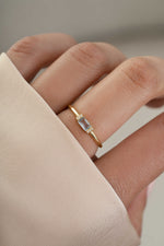 Model wearing gold blue topaz gemstone ring 