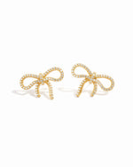 flat lay of diamond earrings, featuring a bow-shaped design with sparkling cubic zirconia stones.
